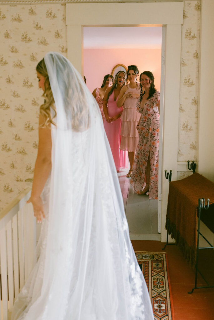 bridesmaids first look with bride in historical new england house
