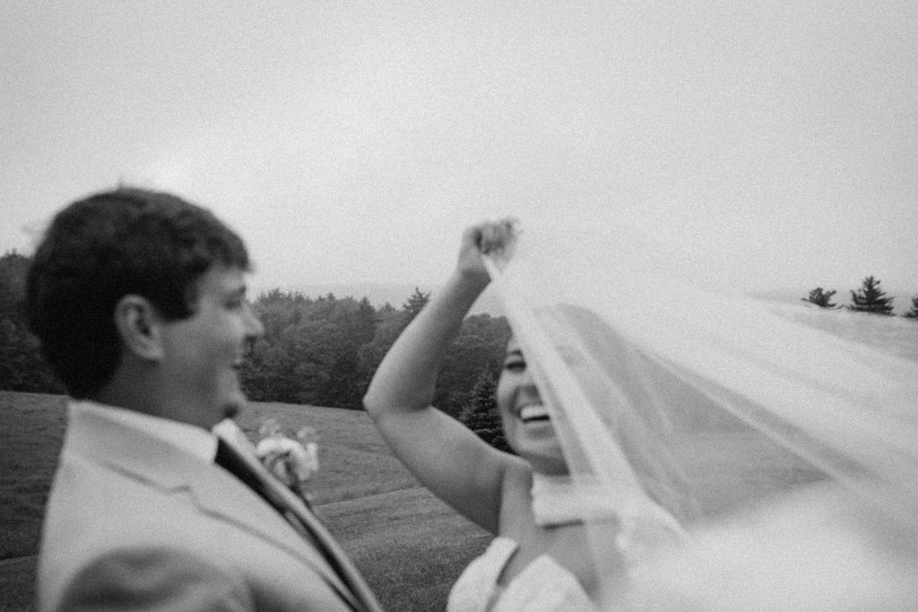 Bride & groom under the veil laughing with joy black & white image Saddle Hill Farm wedding