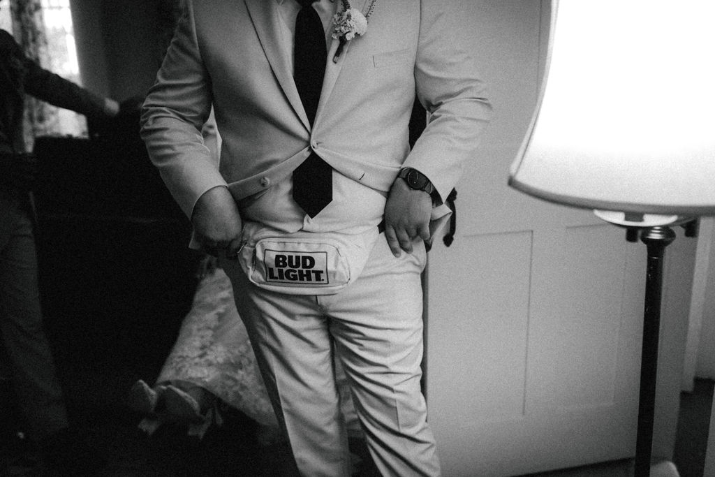 flower man showing off his bud light flower fanny pack 