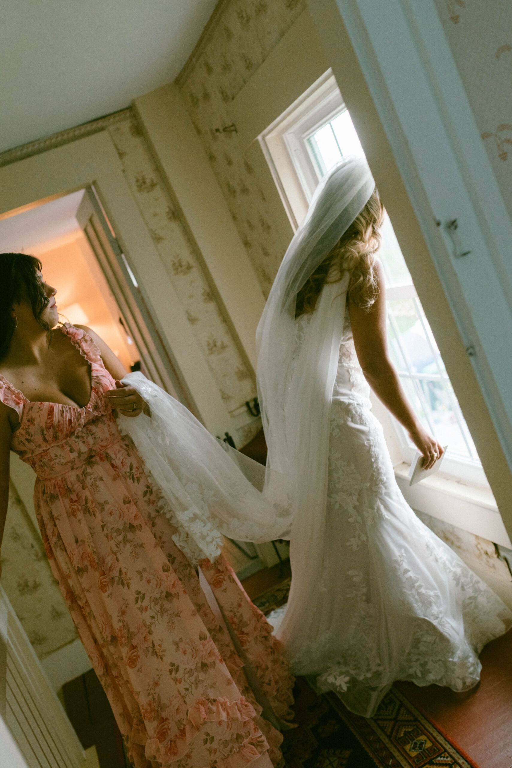 bride peeking out window towards ceremony Saddle Hill Farm wedding