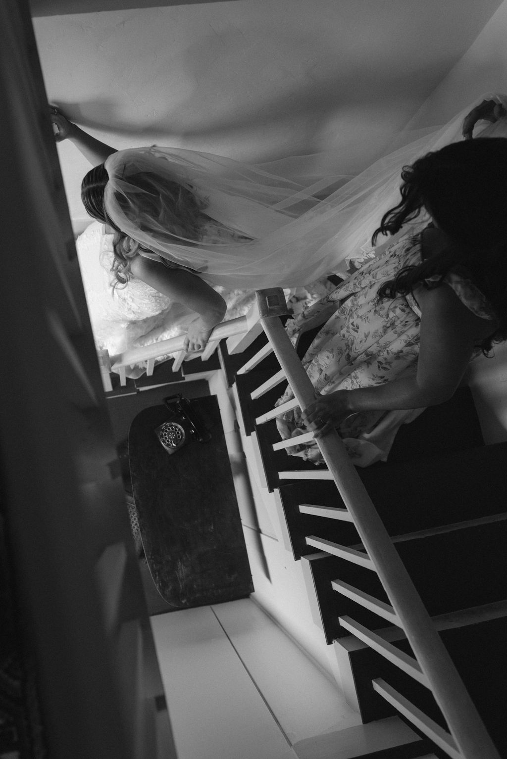 Bride & Bridesmaid walking down the stairs in a historic new england home Black & White Saddle Hill Farm wedding