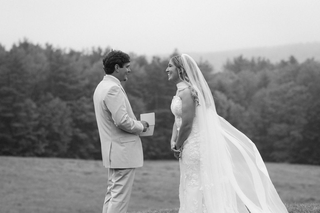 Bride & Groom reading private vows to each other 