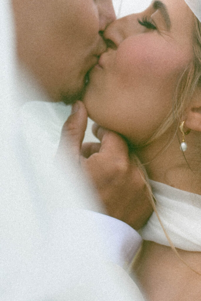 Bride & Groom kiss under the veil 