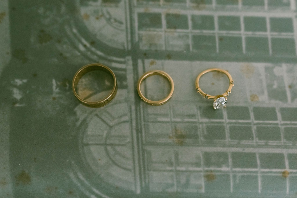 three rings on a book background Saddle Hill Farm wedding