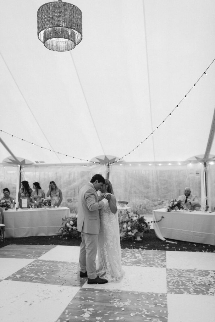 bride & groom first dance on checkered dance floor 