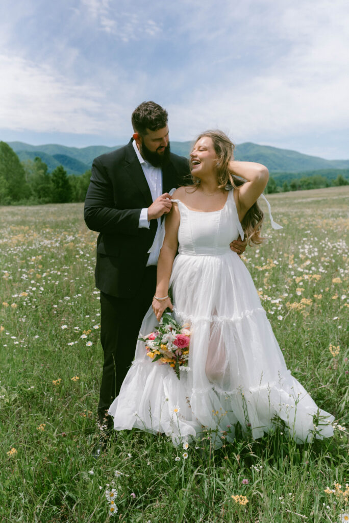Your Dream Guide to a Smoky Mountain Elopement Bride & Groom in a field of wildflowers