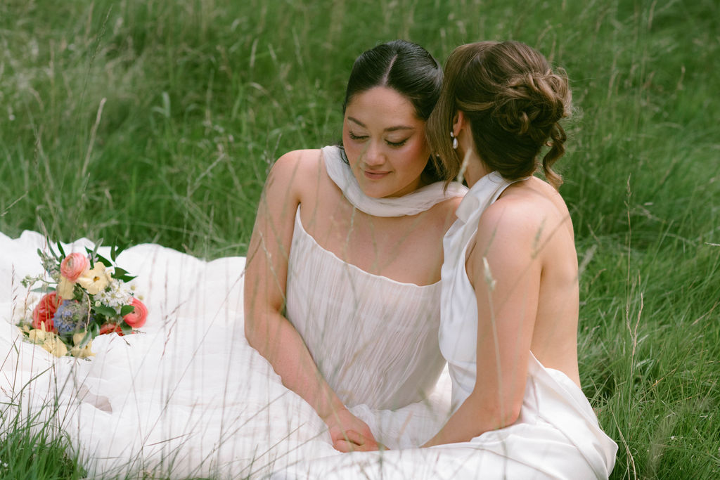 An Upstate New York Wedding at Woodhouse Lodge two brides in the grass