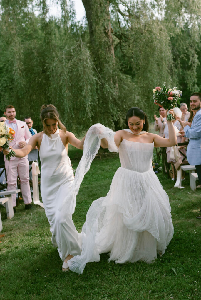 An Upstate New York Wedding at Woodhouse Lodge brides ceremony exit LGBTQ wedding
