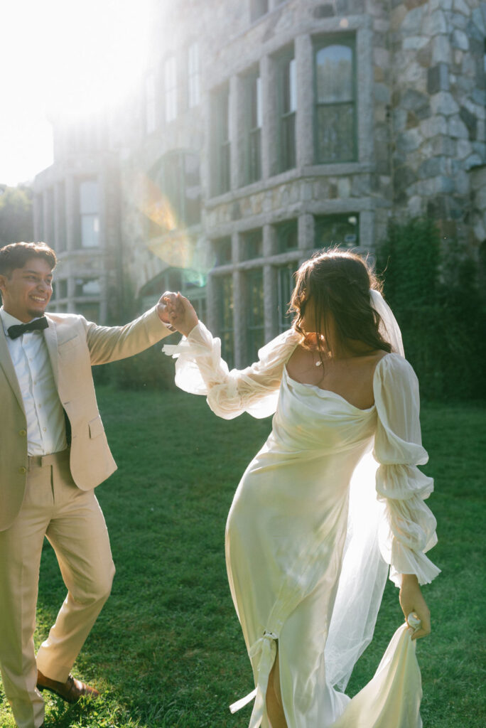 bride and groom holding hands dancing during their photoshoot at their romantic wedding day