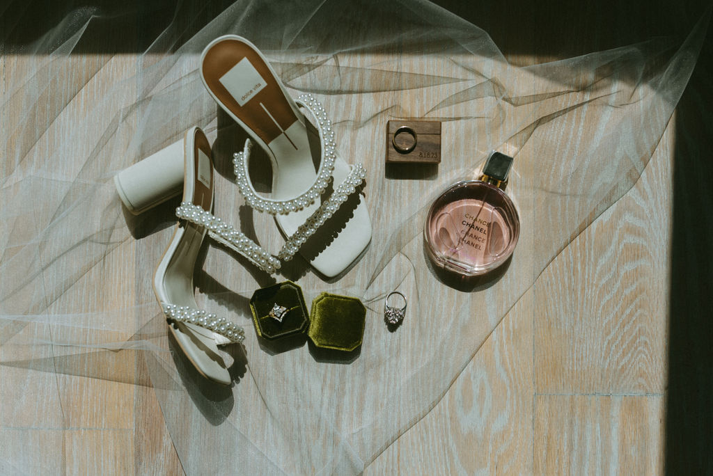 photo of the brides wedding shoes, perfume and rings