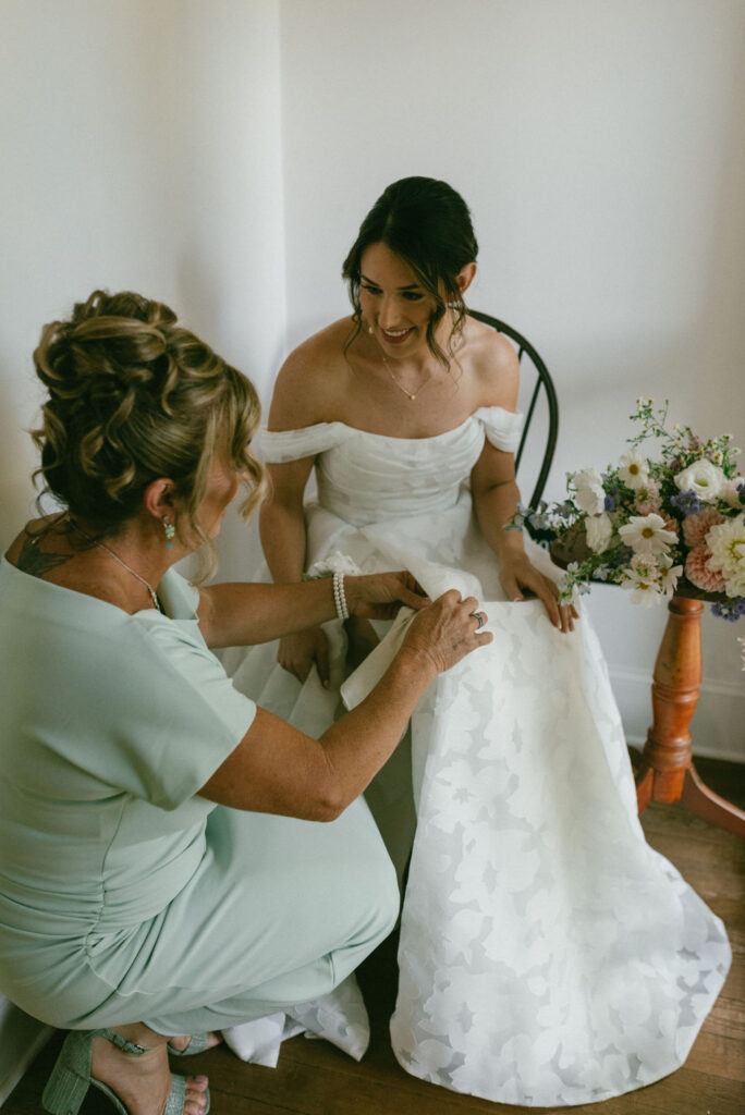 mother of the bride helping her get ready for her fall mountain wedding 