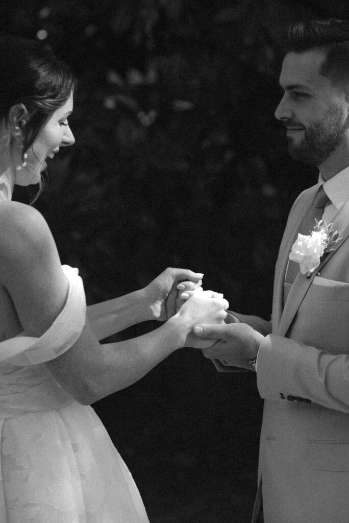 bride and groom holding hands after first look
