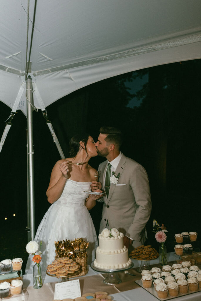 couple kissing at their fall mountain wedding reception