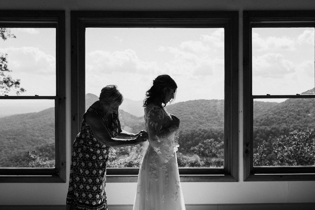 grandma helping the bride with her dress