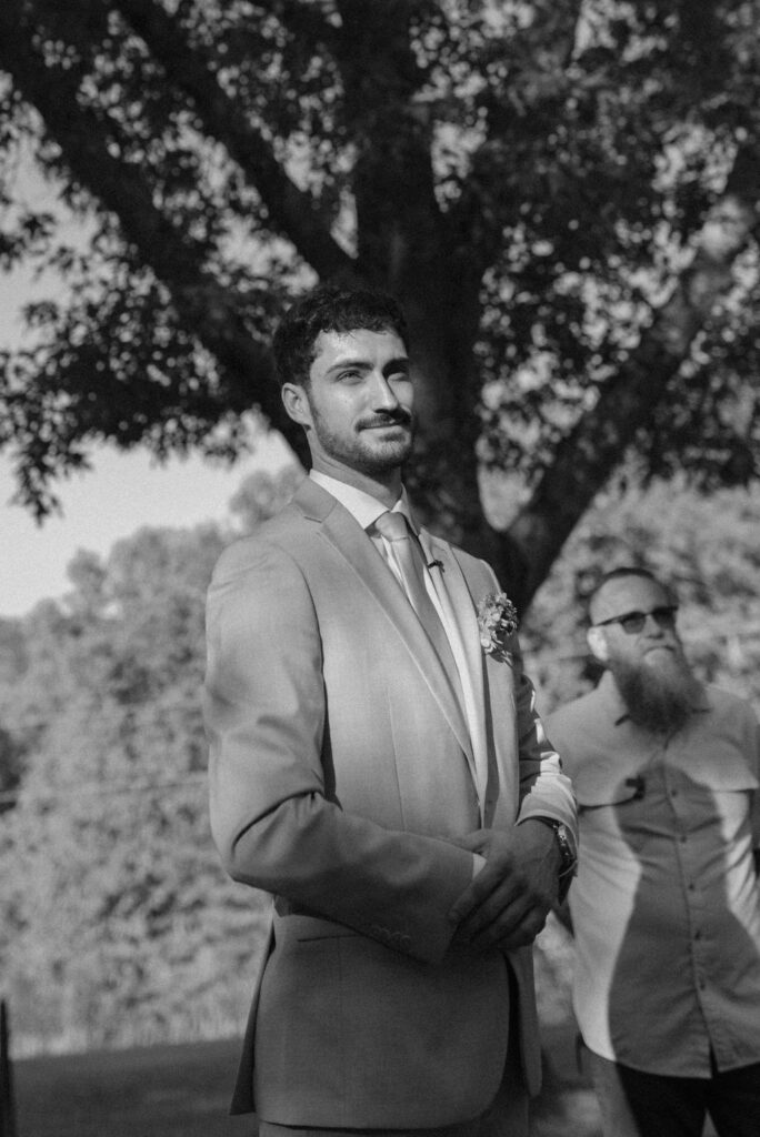 groom looking at the bride during their intimate backyard wedding 