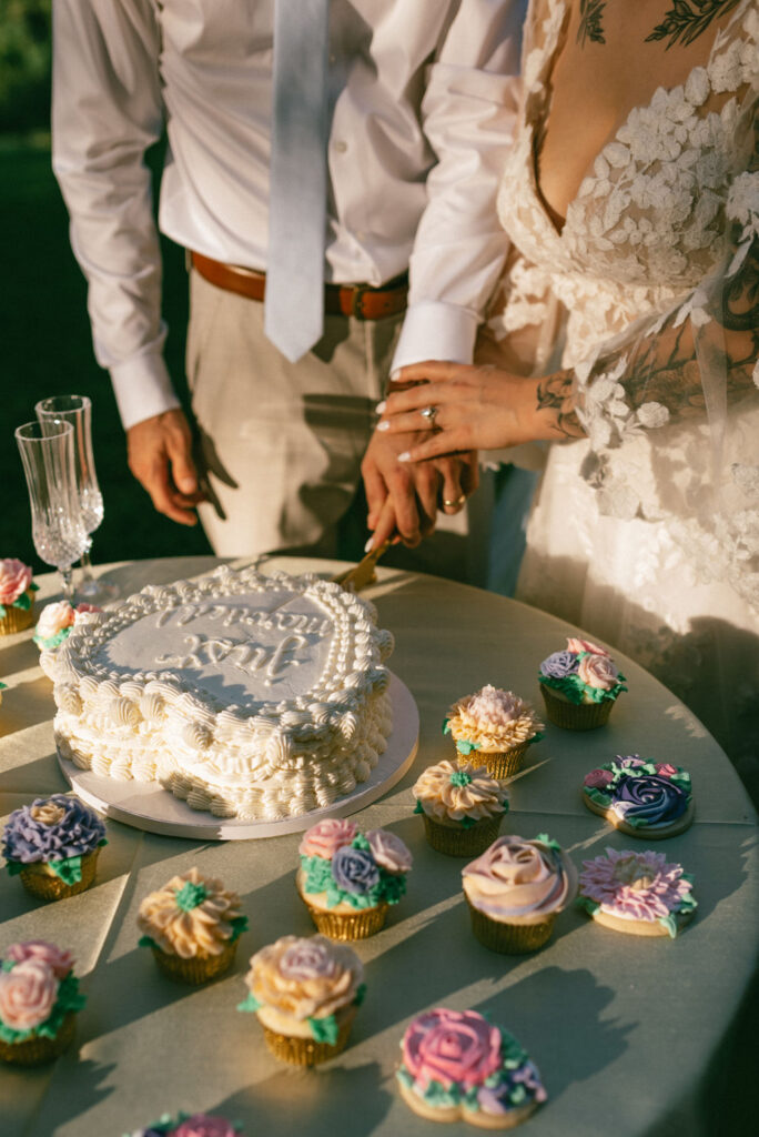 couple cutting the cake at their intimate backyard wedding 