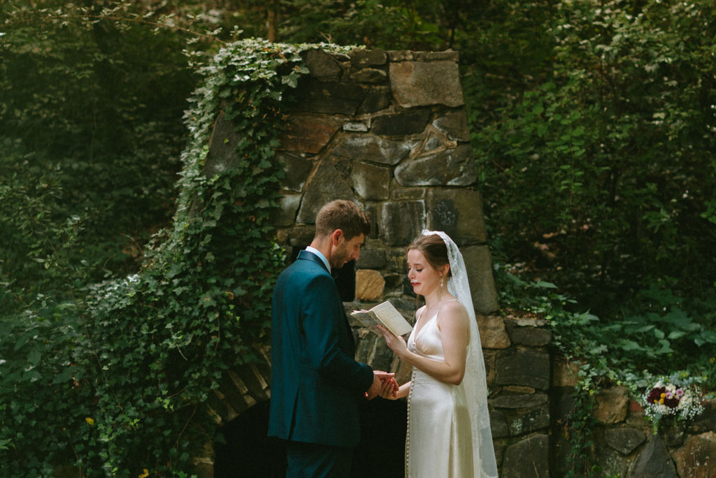 cute couple reading their vows at their italian garden wedding