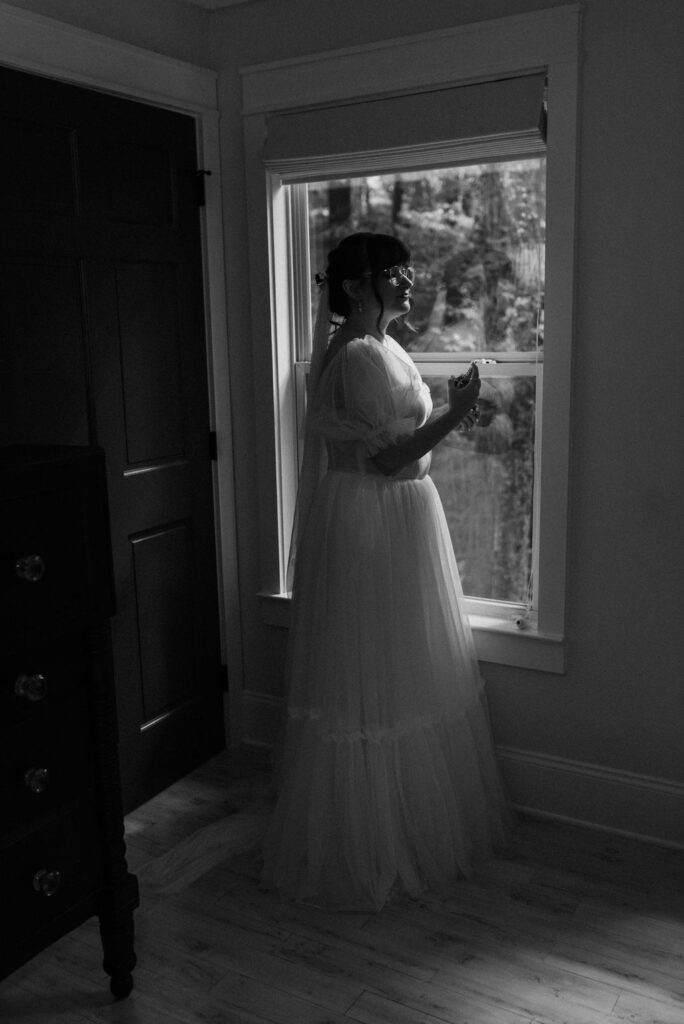 bride putting on perfume before her wedding ceremony 