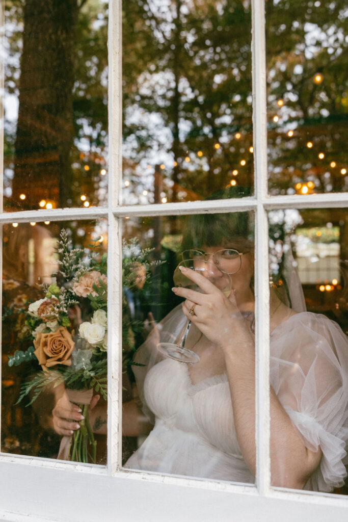 bride drinking champagne at her wedding reception