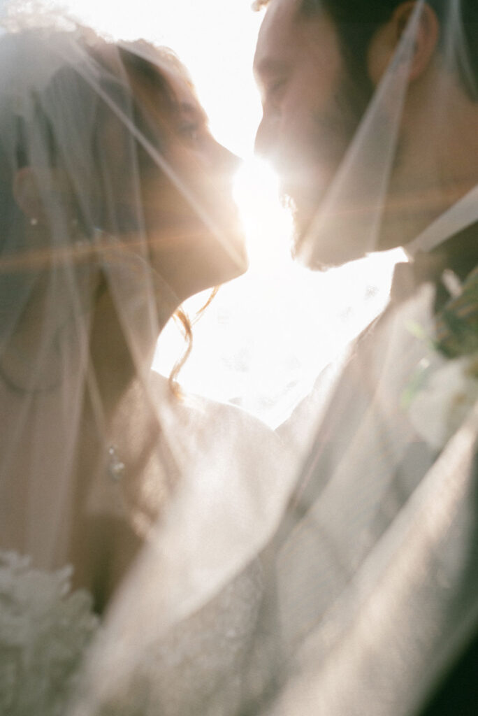 stunning picture of the bride and groom with the sun in the background