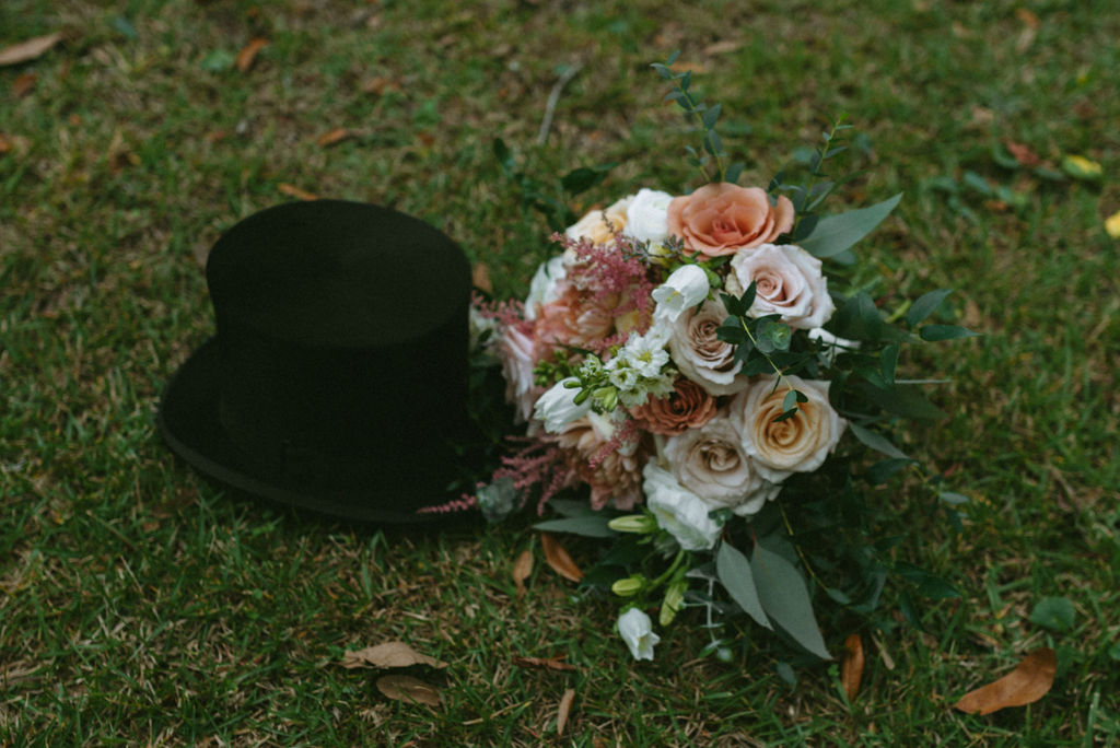 grooms hat and the bouquet the bride use for the wedding ceremony 