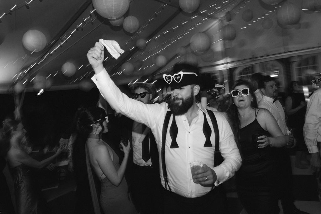 Reception at Cheekwood Estate with checkered dance floor. Bride & groom dancing Groom swinging handkerchief