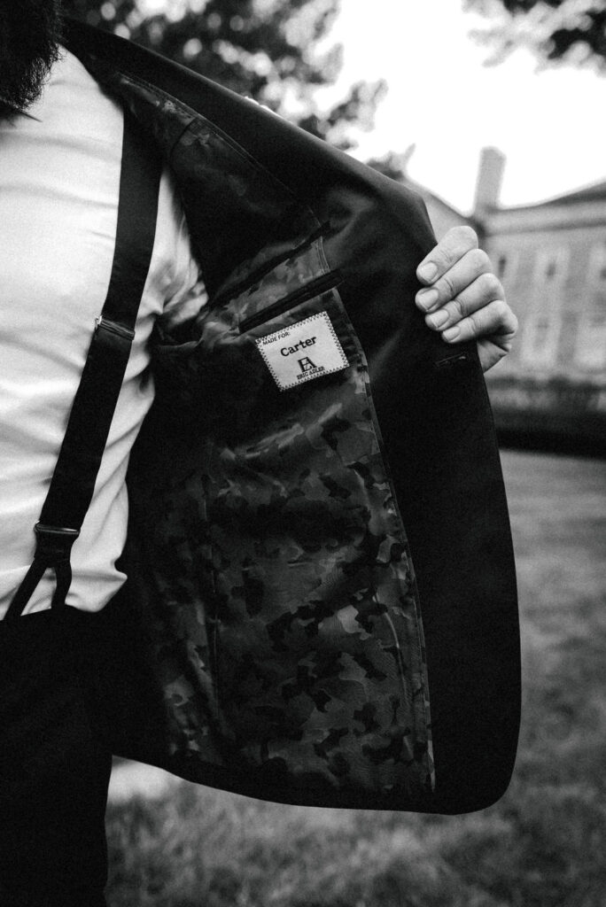 Groom suite jacket label in black & white in front of Cheekwood Estate