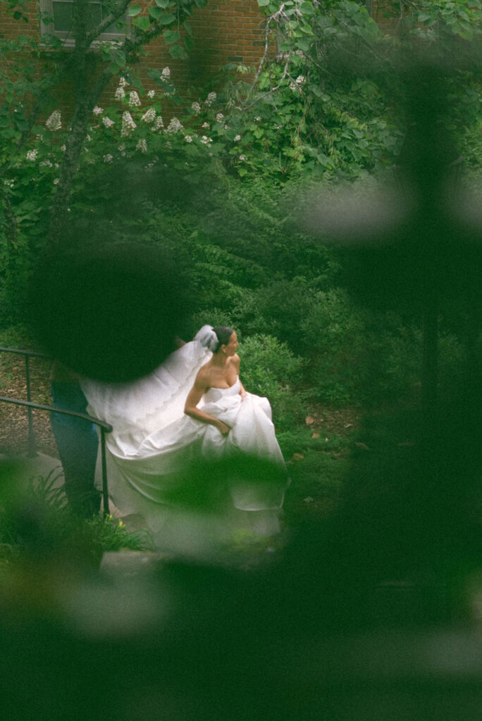 Bride walking up the steps towards first look with Groom