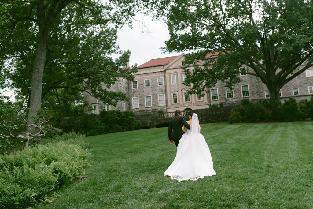 Bride & Groom running in grass at Cheekwood Estate 