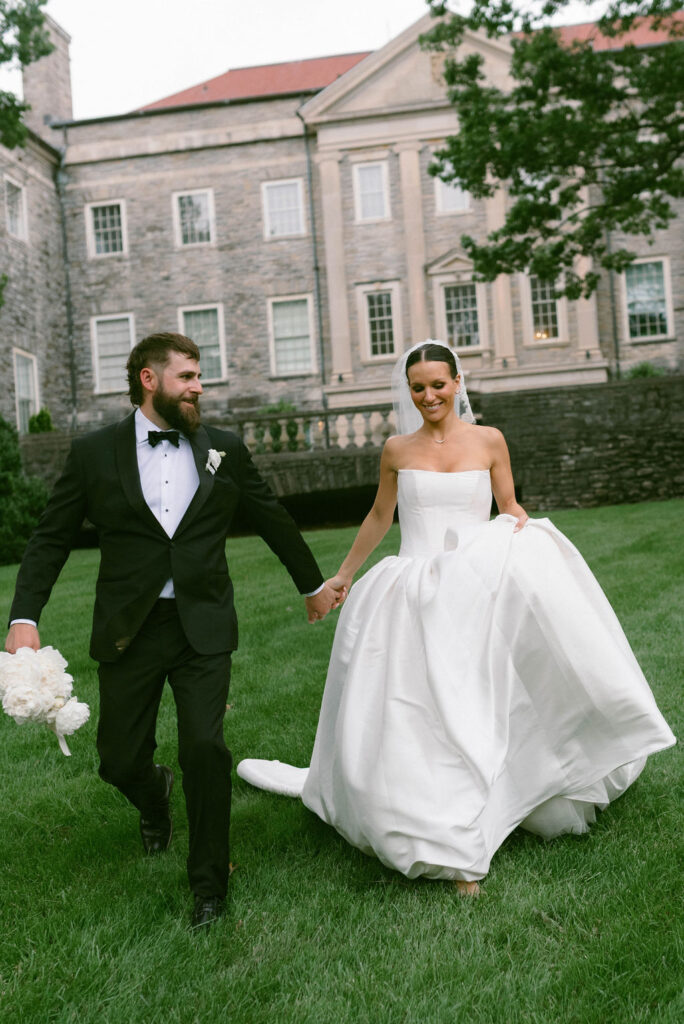 bride & groom running in grass at Cheekwood Estate