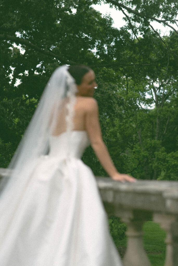 Bridal portrait elegant bride leaving over stone wall