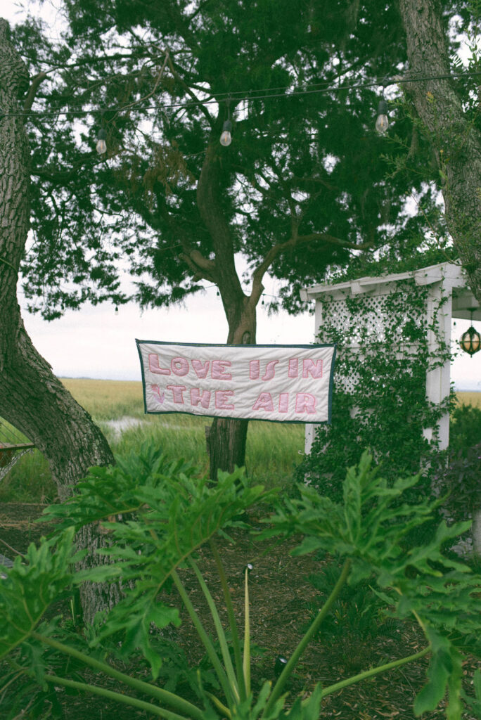 love is in the air fabric embroidery banner sign at elopement on tybee island