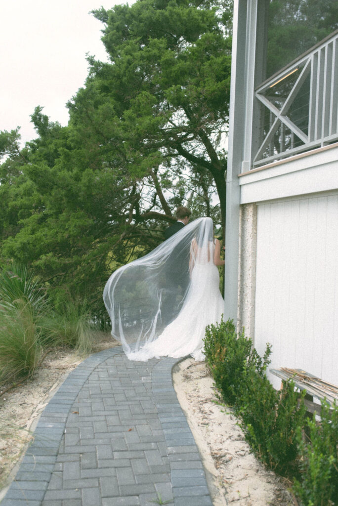 Bride's veil flowing in the wind after exiting wedding ceremony as husband and wife