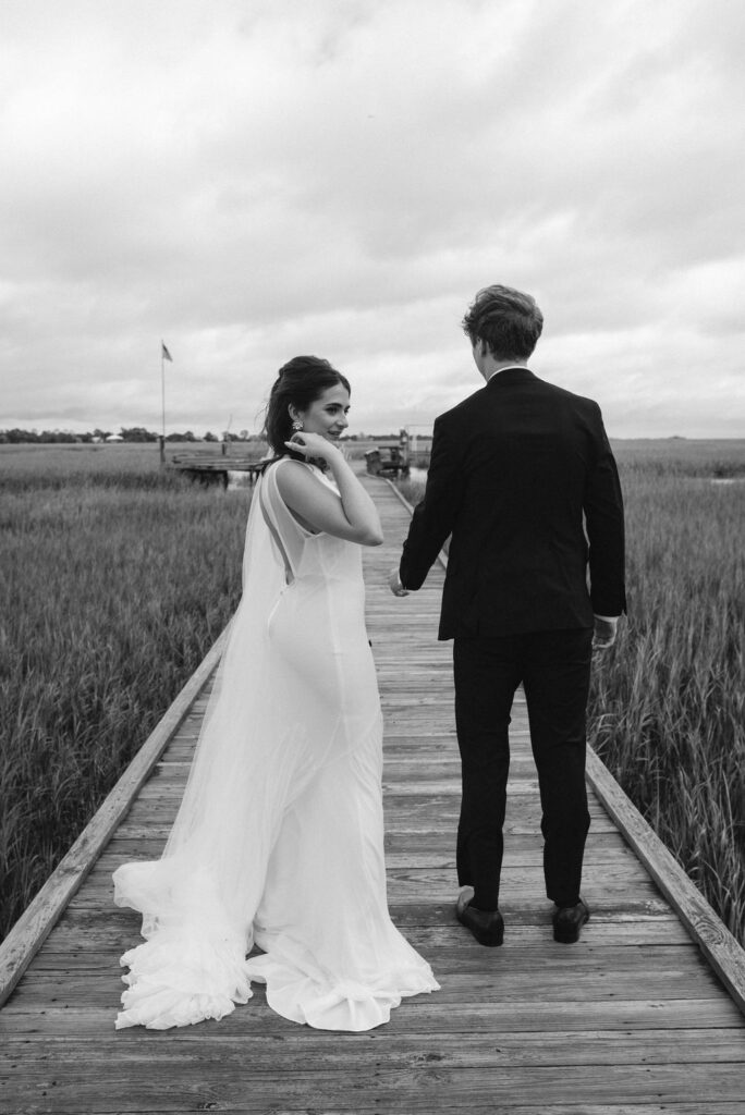 Bride & groom on dock overlooking the marsh on Tybee Island