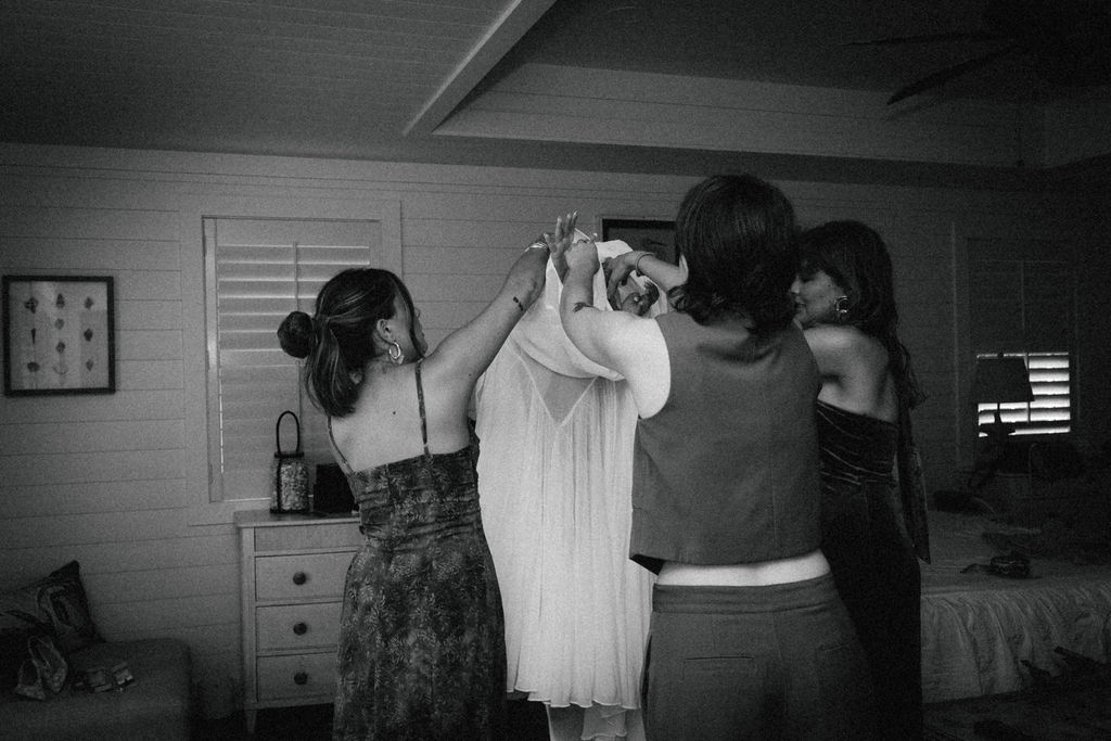 Bride & her friends helping her get ready at tybee island intimate wedding
