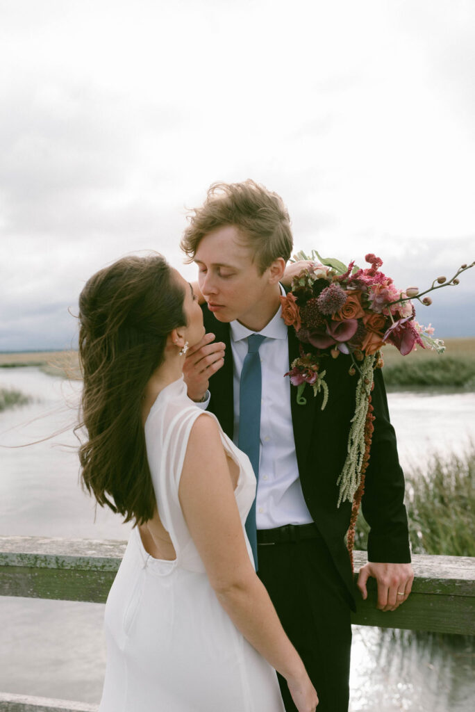 bride & groom kissing in the sunset on a dock on Tybee Island