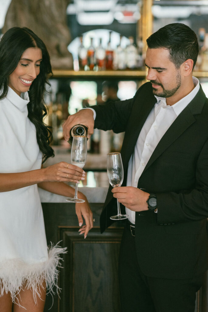 couple drinking champagne eat their romantic engagement session 