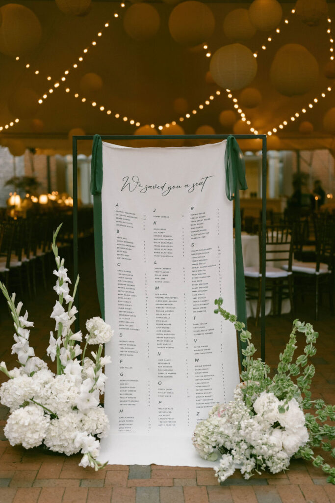 Reception at Cheekwood Estate String Lights with olive green tablecloths and hydrangeas on the tables