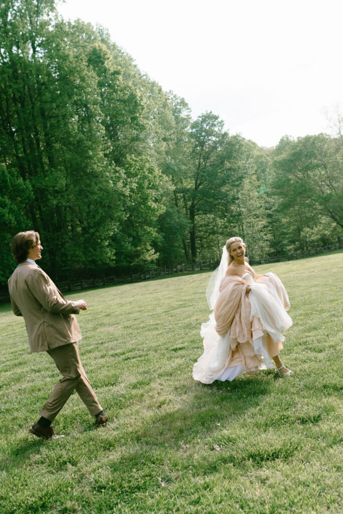 Bride and groom celebrating in field after wedding fairytale bride