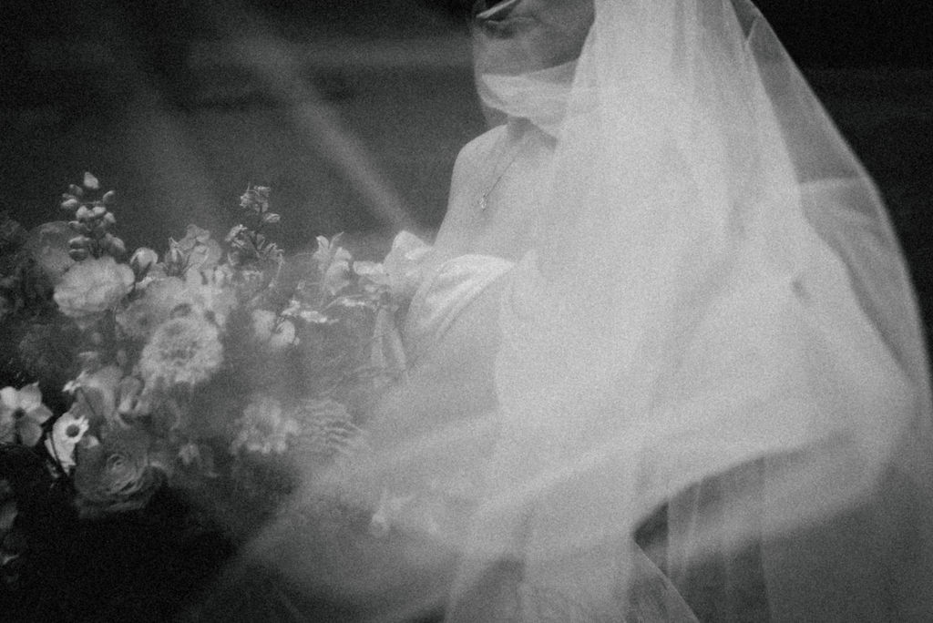 Beautiful black and white portrait of bride with veil 