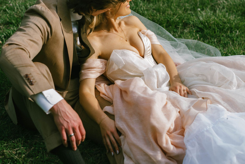 Bride and groom celebrating in field after wedding fairytale bride