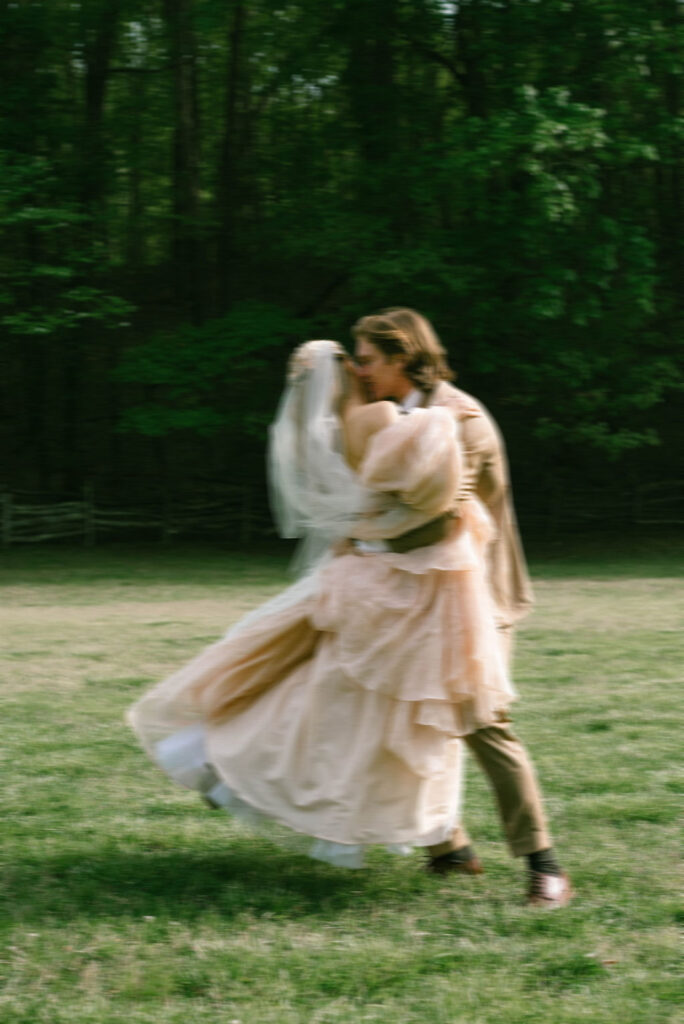 Bride and groom celebrating in field after wedding fairytale bride