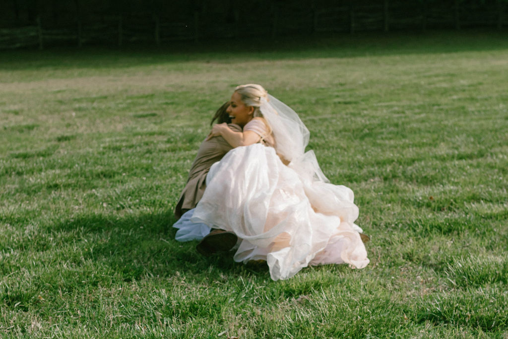 Bride and groom celebrating in field after wedding fairytale bride