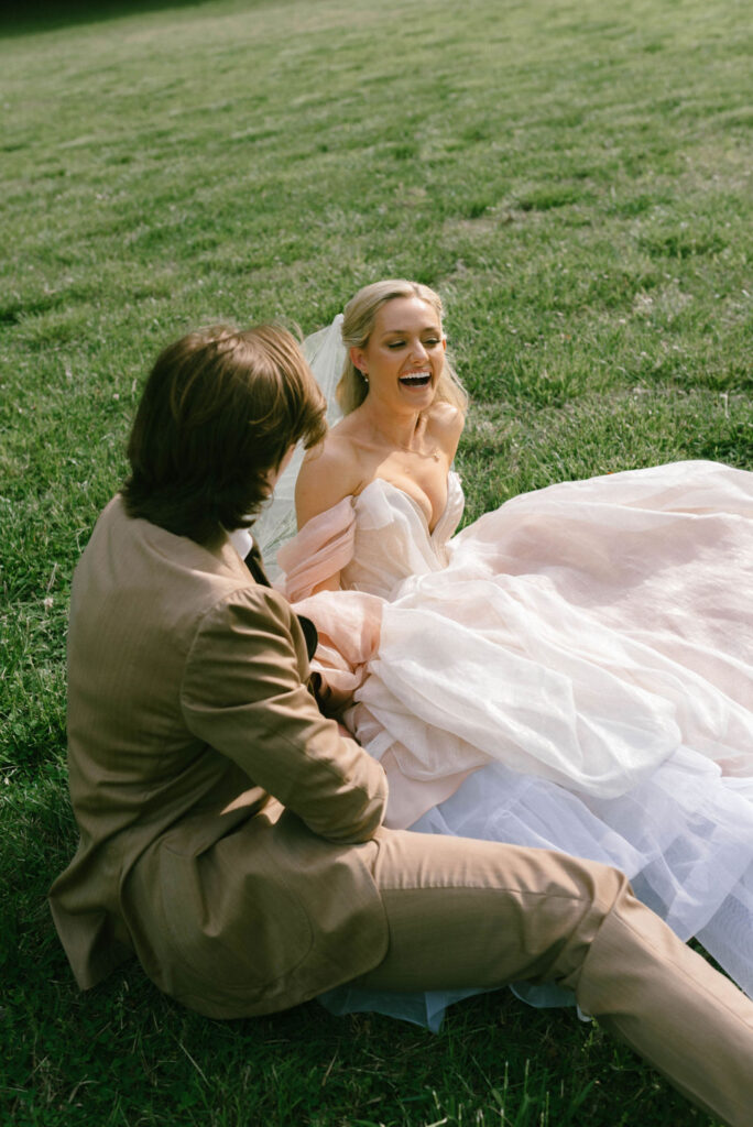 Bride and groom celebrating in field after wedding fairytale bride