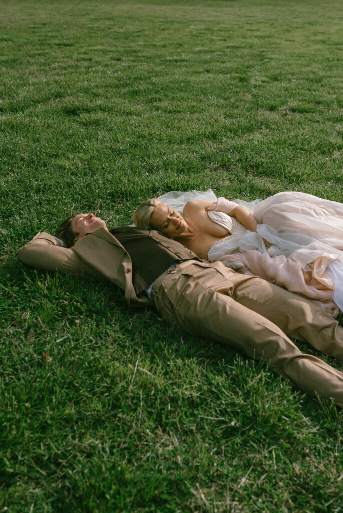 Bride and groom celebrating in field after wedding fairytale bride