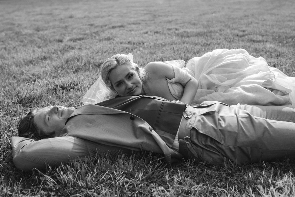 Bride and groom celebrating in field after wedding fairytale bride