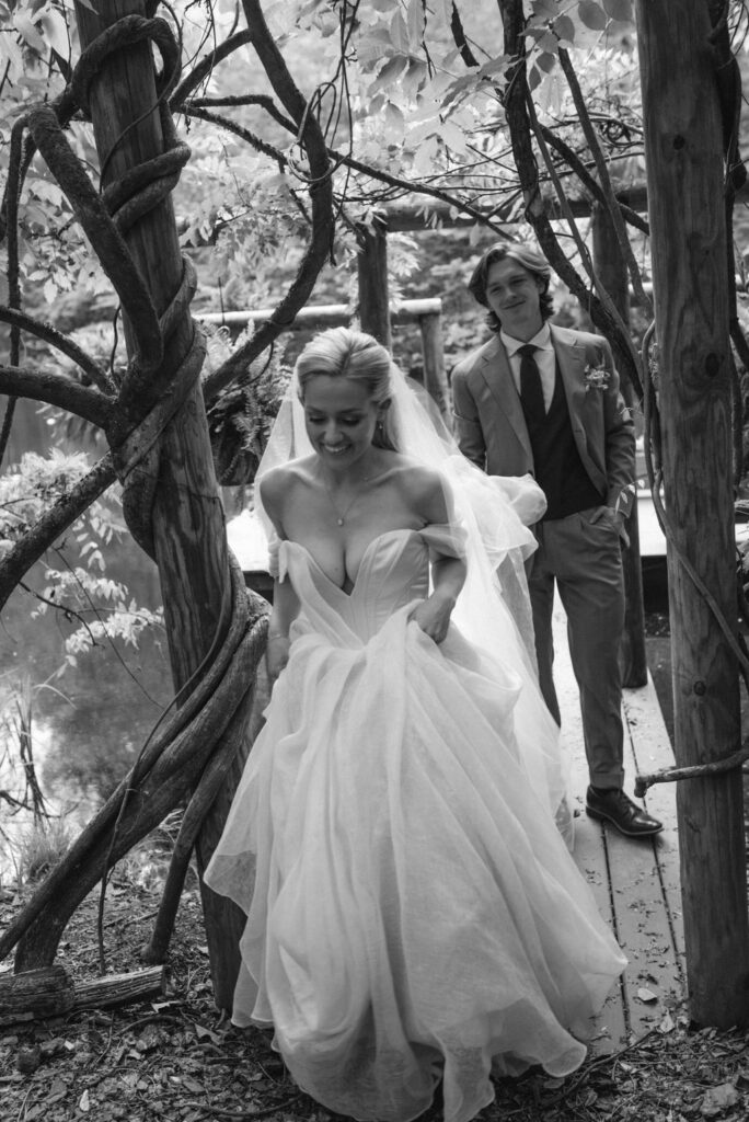 Bride and groom celebrating in field after wedding fairytale bride