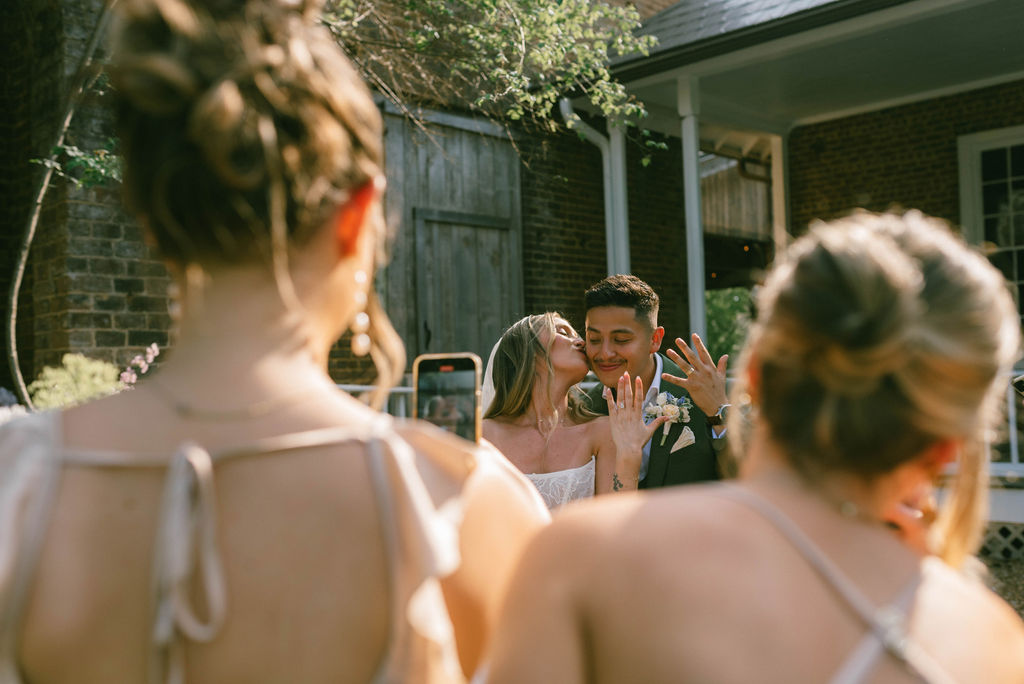 Bride and groom showing off their wedding rings