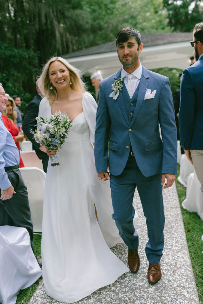 bride and groom walking down the isle 