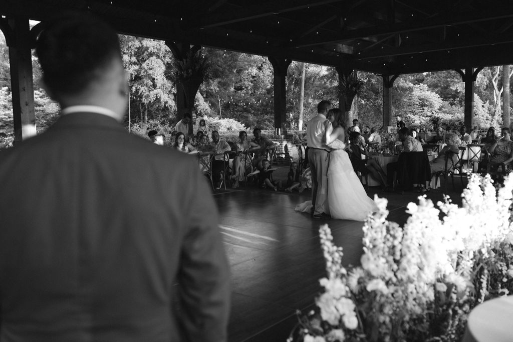 Groom watching the father daughter dance